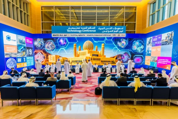 A vibrant scene of an international technology conference in Muscat, Oman. The image features a modern conference hall with attendees from various industries