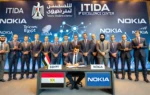 A professional business signing ceremony in a modern conference hall, featuring representatives from Egypt, Telecom Egypt, ITIDA, and Nokia. The backd